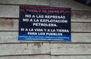 A sign in Copal AA La Esperanza, Cobán, Alta Verapaz, one of the ACODET communities, reads: "In the community consultation of good faith the people of Ixcán said: no to the dams, no to petroleum exploitation, yes to life and land for indigenous peoples. ILO Convention 169 Article 1: The right to consultation and free, prior, and informed consent."