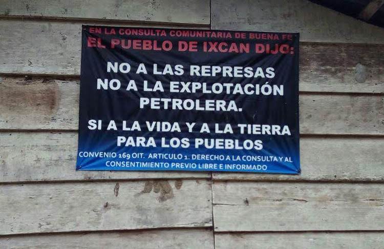 A sign in Copal AA La Esperanza, Cobán, Alta Verapaz, one of the ACODET communities, reads: "In the community consultation of good faith the people of Ixcán said: no to the dams, no to petroleum exploitation, yes to life and land for indigenous peoples. ILO Convention 169 Article 1: The right to consultation and free, prior, and informed consent."