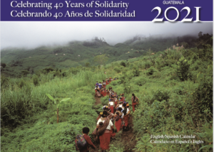 2021 Calendar cover. Image of CPR community members walking on a small path through green mountains. Reads: Celebrating 40 years of Solidarity, Guatemala 2021