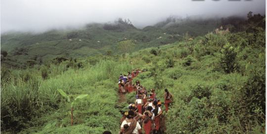 2021 Calendar cover. Image of CPR community members walking on a small path through green mountains. Reads: Celebrating 40 years of Solidarity, Guatemala 2021
