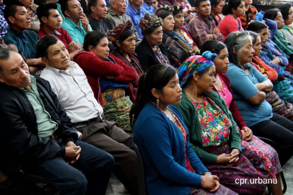 AJR members listening at a Guatemalan court