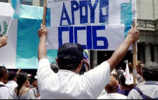 A protestor holds a sign at a pro-CICIG rally that says "Apoyo CICIG," or, "I support CICIG."