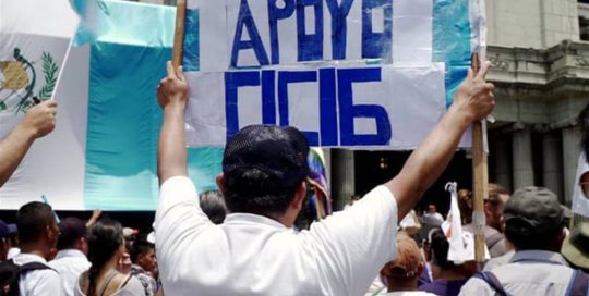 A protestor holds a sign at a pro-CICIG rally that says "Apoyo CICIG," or, "I support CICIG."