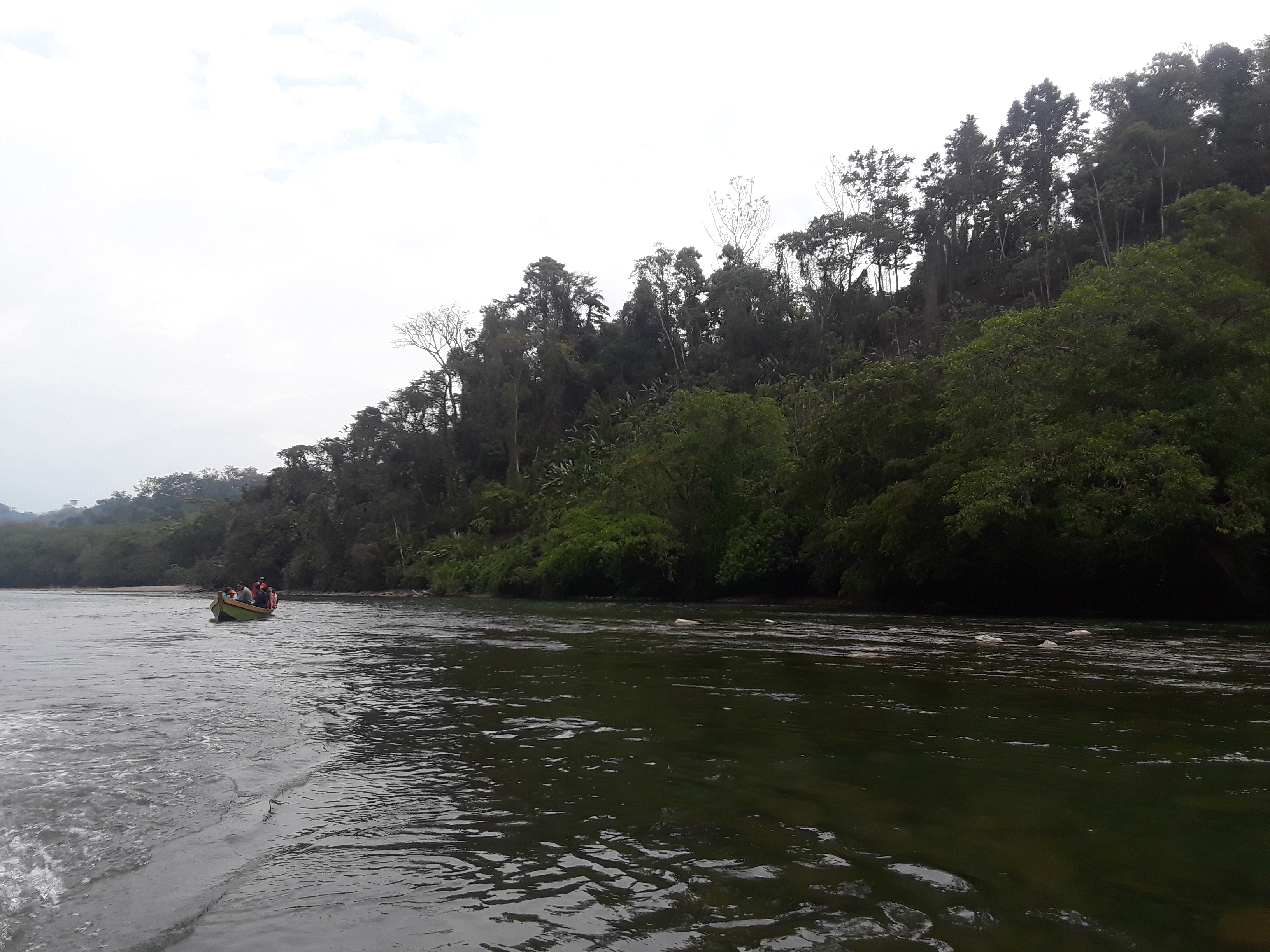 A boat filled with delegates and community members in the Chixoy River. Photo credit: Claire Bransky