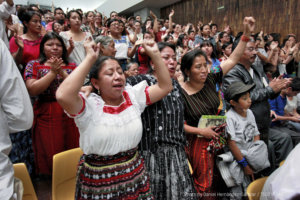 People cheer after the judges announce a guilty verdict against Ríos Montt in 2013.