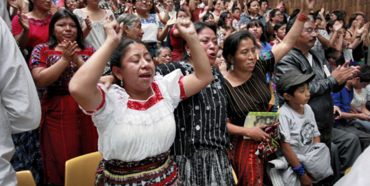 People cheer after the judges announce a guilty verdict against Ríos Montt in 2013.