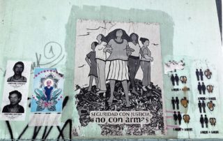 Street art in a wall at Guatemala City depicting in the center an image of women standing and protecting themselves with the legend "Security with justice not with weapons". In the left, pictures of disappeared during the Internal Armed conflict and of Jackelin Call who died under ICE custody. To the right a graffiti showing different couples equals love