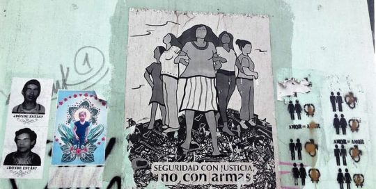 Street art in a wall at Guatemala City depicting in the center an image of women standing and protecting themselves with the legend "Security with justice not with weapons". In the left, pictures of disappeared during the Internal Armed conflict and of Jackelin Call who died under ICE custody. To the right a graffiti showing different couples equals love