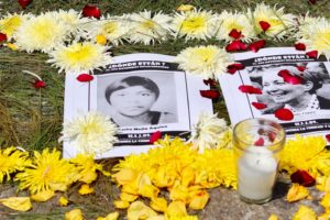 black and white pictures of guatemalan dessapeared are laying in the ground surrounded by flowers and candles