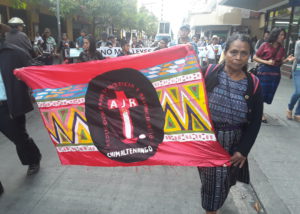 Martina Bar Sunun, first spokesperson for the board of the AJR, marches with a sign representing the AJR.