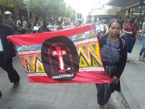 Martina Bar Sunun, first spokesperson for the board of the AJR, marches with a sign representing the AJR.