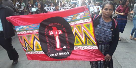 Martina Bar Sunun, first spokesperson for the board of the AJR, marches with a sign representing the AJR.