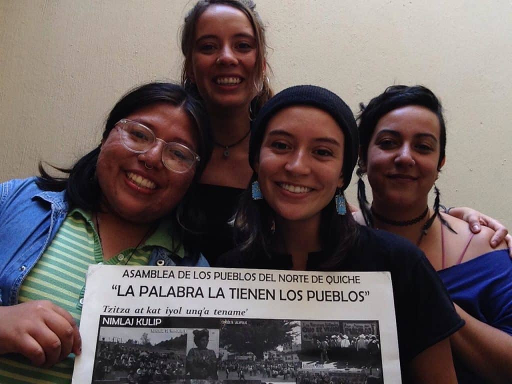 4 NISGUA accompaniers hold a sign that says "People have the word"