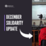 Graphic that reads "December Solidarity Update" with an arrow