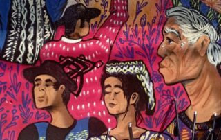 In the image painted in graffiti are five indigenous peoples, a grandmother, a woman and three men, two of them sideways and each one of them holding their staff of command and the phrase "You will flourish Guatemala", leaning against the wall are five backpacks with several staffs of command.